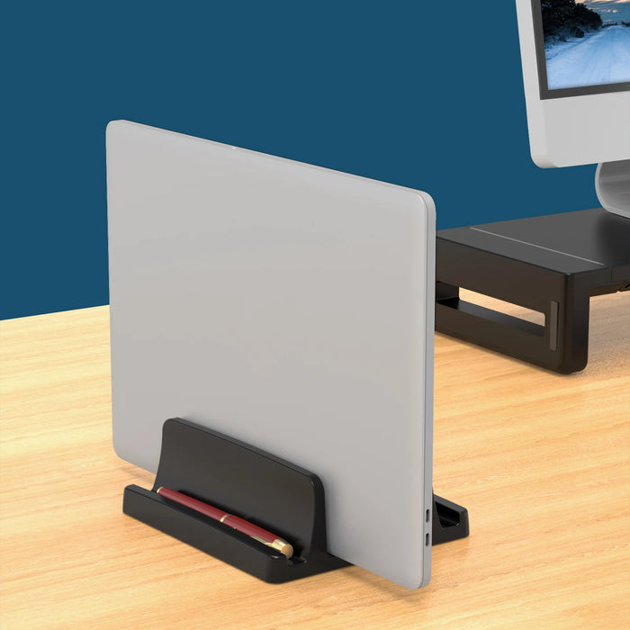 Vertical laptop dock holding a closed laptop on its edge